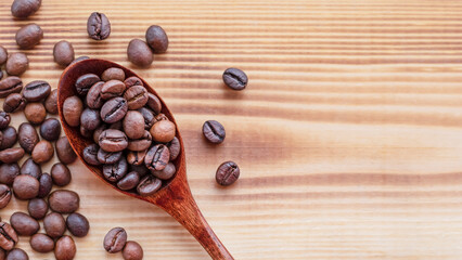 wooden spoon with coffee beans on the table