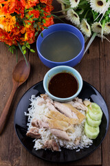 Thai food gourmet steamed chicken with rice , khao mun kai in wood background