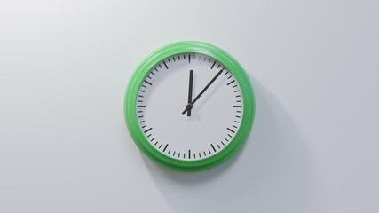 Glossy green clock on a white wall at seven past twelve. Time is 00:07 or 12:07