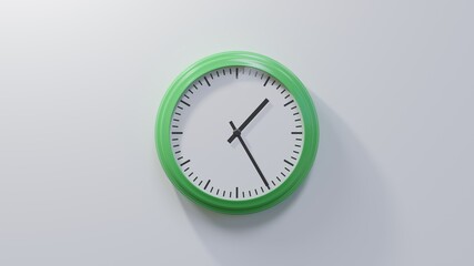 Glossy green clock on a white wall at twenty-five past one. Time is 01:25 or 13:25