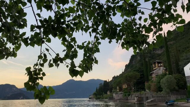 Panning video showing the amazing sunset over Lake Como on summertime, Lierna, Lecco, Italy