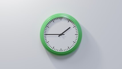 Glossy green clock on a white wall at quarter to two. Time is 01:45 or 13:45