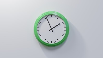 Glossy green clock on a white wall at fifty-six past one. Time is 01:56 or 13:56