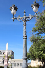Classic lamppost of gray color of two lamps of the city Maceio.
