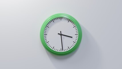 Glossy green clock on a white wall at twenty-nine past three. Time is 03:29 or 15:29