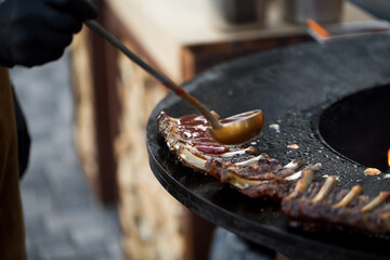 Grilled pork baby ribs with barbecue sauce on the grill. Festival street food