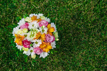 bouquet of colorful flowers on green lawn. place for text.