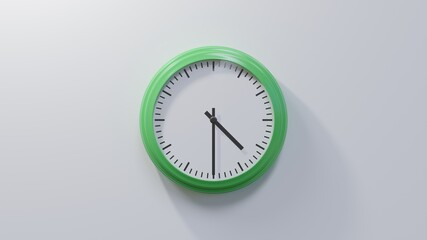Glossy green clock on a white wall at half past four. Time is 04:30 or 16:30
