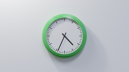 Glossy green clock on a white wall at thirty-four past four. Time is 04:34 or 16:34