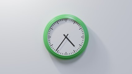 Glossy green clock on a white wall at thirty-six past four. Time is 04:36 or 16:36