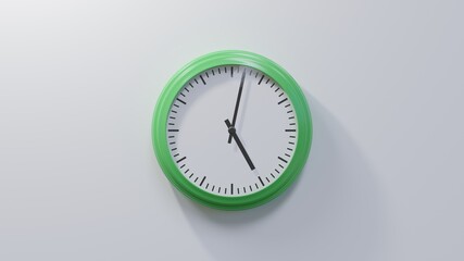 Glossy green clock on a white wall at two past five. Time is 05:02 or 17:02