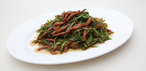 Close up view of  typical Chinese Szechuan cuisine Fried Shredded Pork with green Bell Peppers