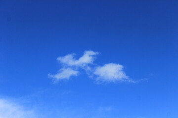 Three small clouds in the sky. Russia.