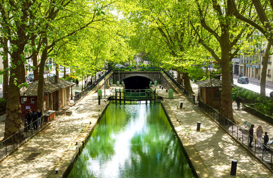 spring in Paris - new greenery reflecting in the water of the Canal Saint Martin, in the newly trendy 10th arrondissement of Paris. 