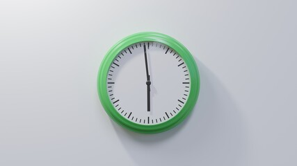 Glossy green clock on a white wall at fifty-nine past five. Time is 05:59 or 17:59