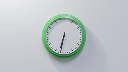 Glossy green clock on a white wall at thirty-two past six. Time is 06:32 or 18:32