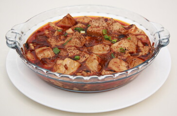 Close up of  popular Chinese dish from the Sichuan province Mapo tofu in glass dish