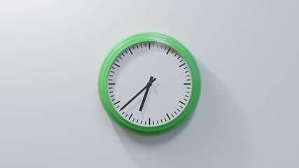 Glossy green clock on a white wall at thirty-eight past six. Time is 06:38 or 18:38
