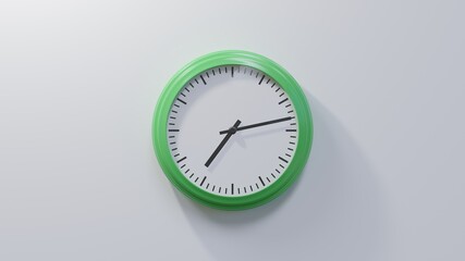 Glossy green clock on a white wall at thirteen past seven. Time is 07:13 or 19:13