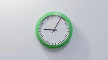 Glossy green clock on a white wall at five past nine. Time is 09:05 or 21:05