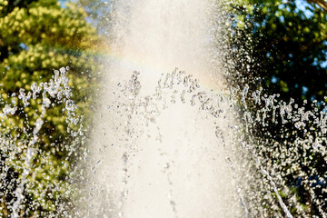 Selective focus on spray of urban fountain and blurred background