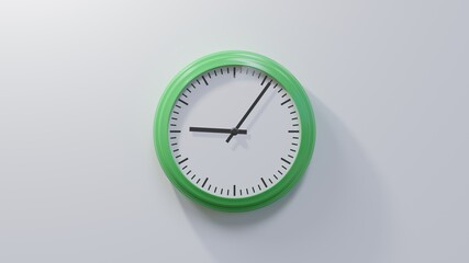 Glossy green clock on a white wall at six past nine. Time is 09:06 or 21:06
