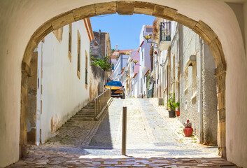 One of the streets of the old town of Lagos in Algarve, seen through the arch.  © rrrainbow