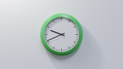 Glossy green clock on a white wall at forty-one past nine. Time is 09:41 or 21:41