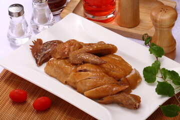 Close up view of  Cantonese and Hong Kong style  cuisine Soya Sauce Chicken with ingredients bottles