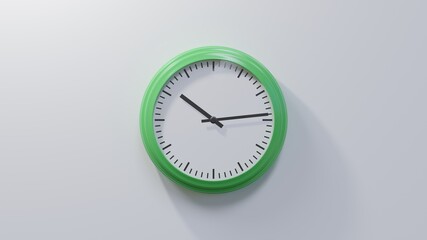Glossy green clock on a white wall at fourteen past ten. Time is 10:14 or 22:14