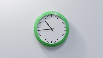 Glossy green clock on a white wall at forty-four past ten. Time is 10:44 or 22:44