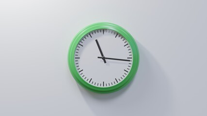 Glossy green clock on a white wall at sixteen past eleven. Time is 11:16 or 23:16