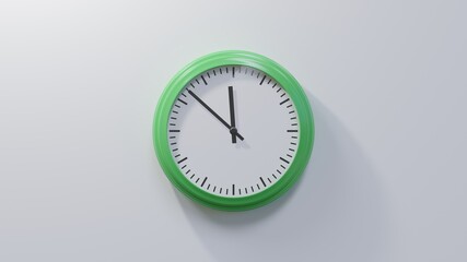 Glossy green clock on a white wall at fifty-two past eleven. Time is 11:52 or 23:52