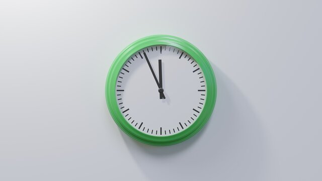 Glossy green clock on a white wall at fifty-six past eleven. Time is 11:56 or 23:56
