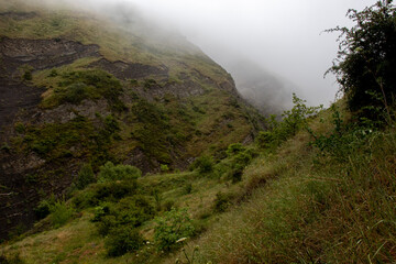 Green mountains in the clouds. Green Caucasus mountains in the clouds. Clouds descend in the...