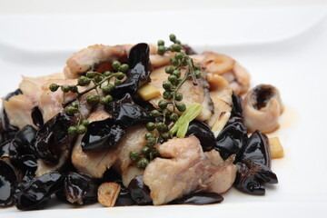 Close up of  a typical Chinese Sichuan province cuisine Fried sliced fish and black fungus with pepper