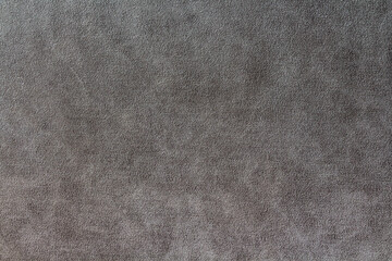 Fototapeta na wymiar Dark grey suede fabric background. Abstract texture wallpaper.