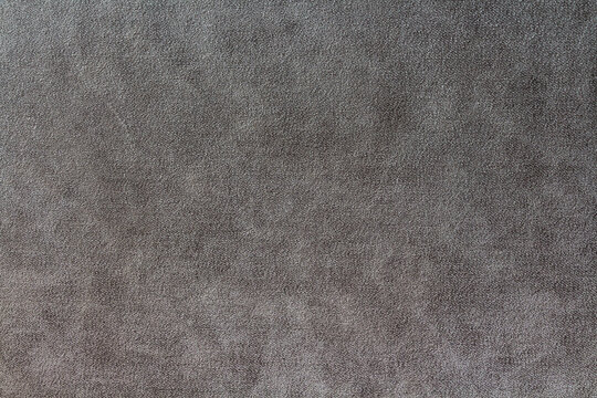 Dark grey suede fabric background. Abstract texture wallpaper.
