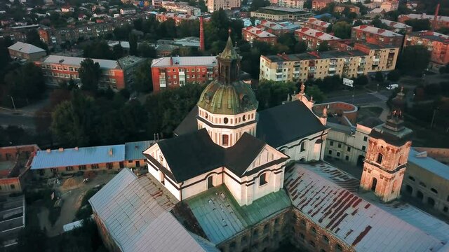 Aerial view of Monastery of the Barefoot Carmelites at sunset, Medieval Catholic ancient fortress in Berdichiv city, Ukraine. Monastery of the Barefoot Carmelites, Aerial survey of Monastery of the Ba