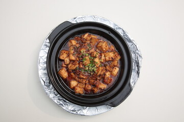 Close up of a typical Cantonese and Hong Kong cuisine Braised diced chicken, salted fish, and Tofu Clay Pot