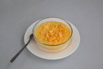 Close up of Hong Kong and Cantonese style dessert Chilled Mango, pomelo and sago with coconut cream in glass bowl