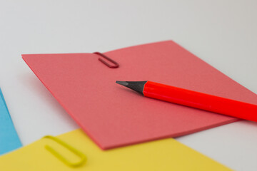 colored stickers note paper and pencil on a white background