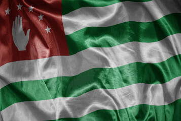 colorful shining big national flag of abkhazia on a silky texture