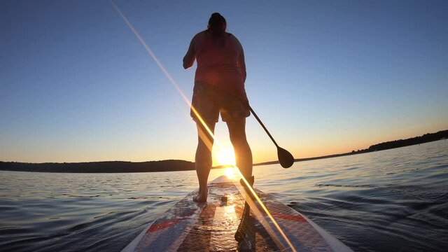 LD Woman paddling on her SUP at sunset