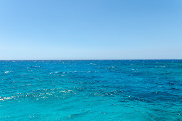 Beautiful emerald sea and clear blue sky. Small waves