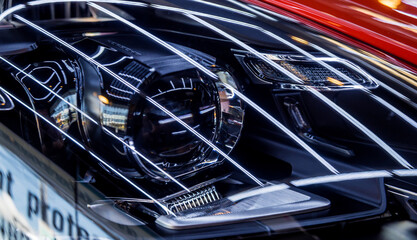 Obraz premium Headlights and details of red sport car