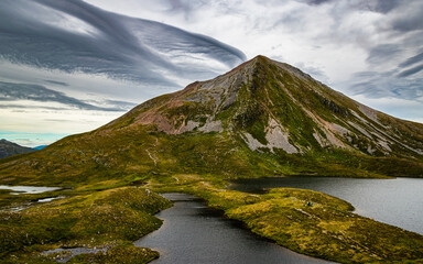 Scottish highlands mountain landscape. Peak of Sgurr Eilde Mor seen across the small lochan from the hiking trail in Mamores range, Scotland © Maritxu22