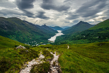 Litttle village of Kinlochleven and Loch Elide on a summer afternoon on an overcast day with clouds on the horizon.