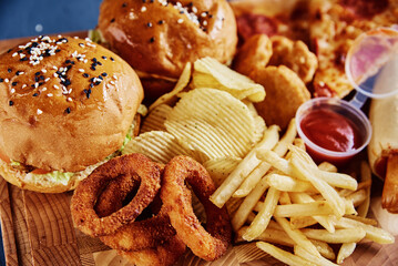 Unhealthy and junk food. Different types of fast food on the table, closeup