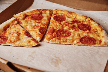 Slice of pizza in cardboard box, closeup